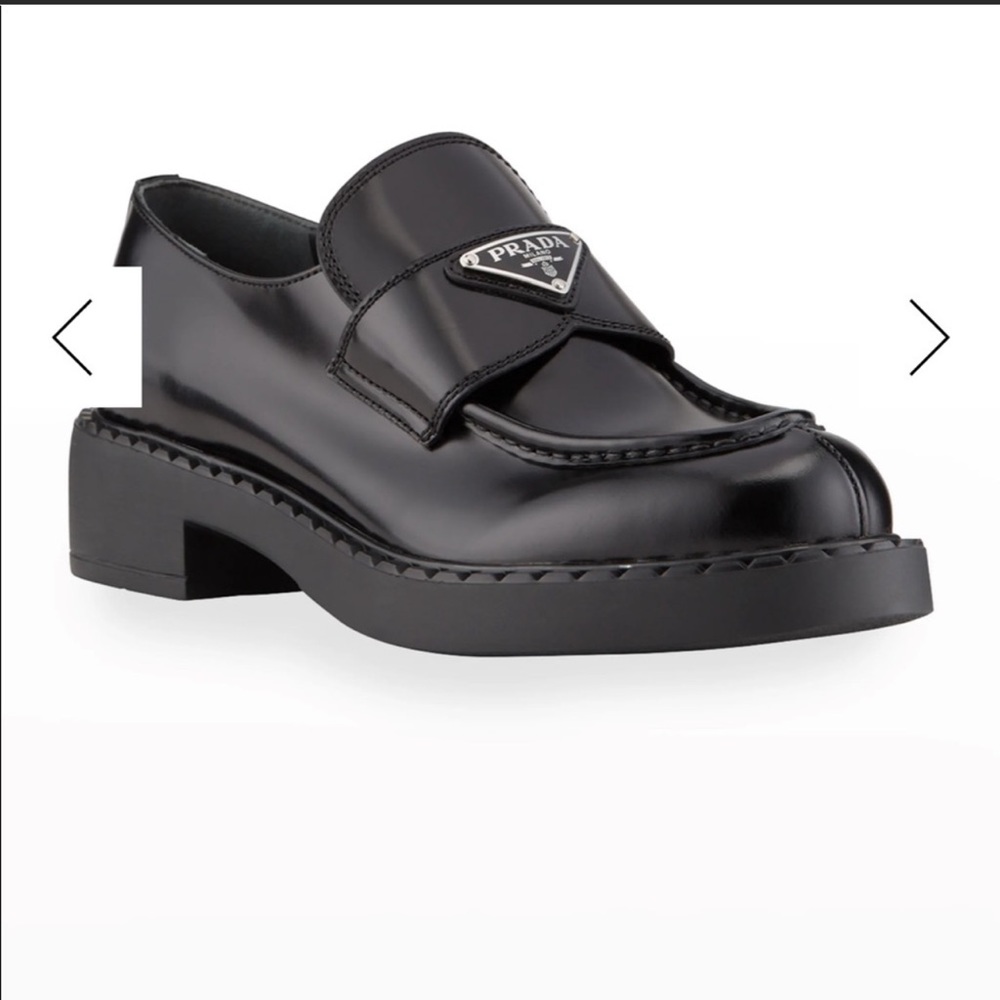 Prada leather loafers with triangle logo keeper.